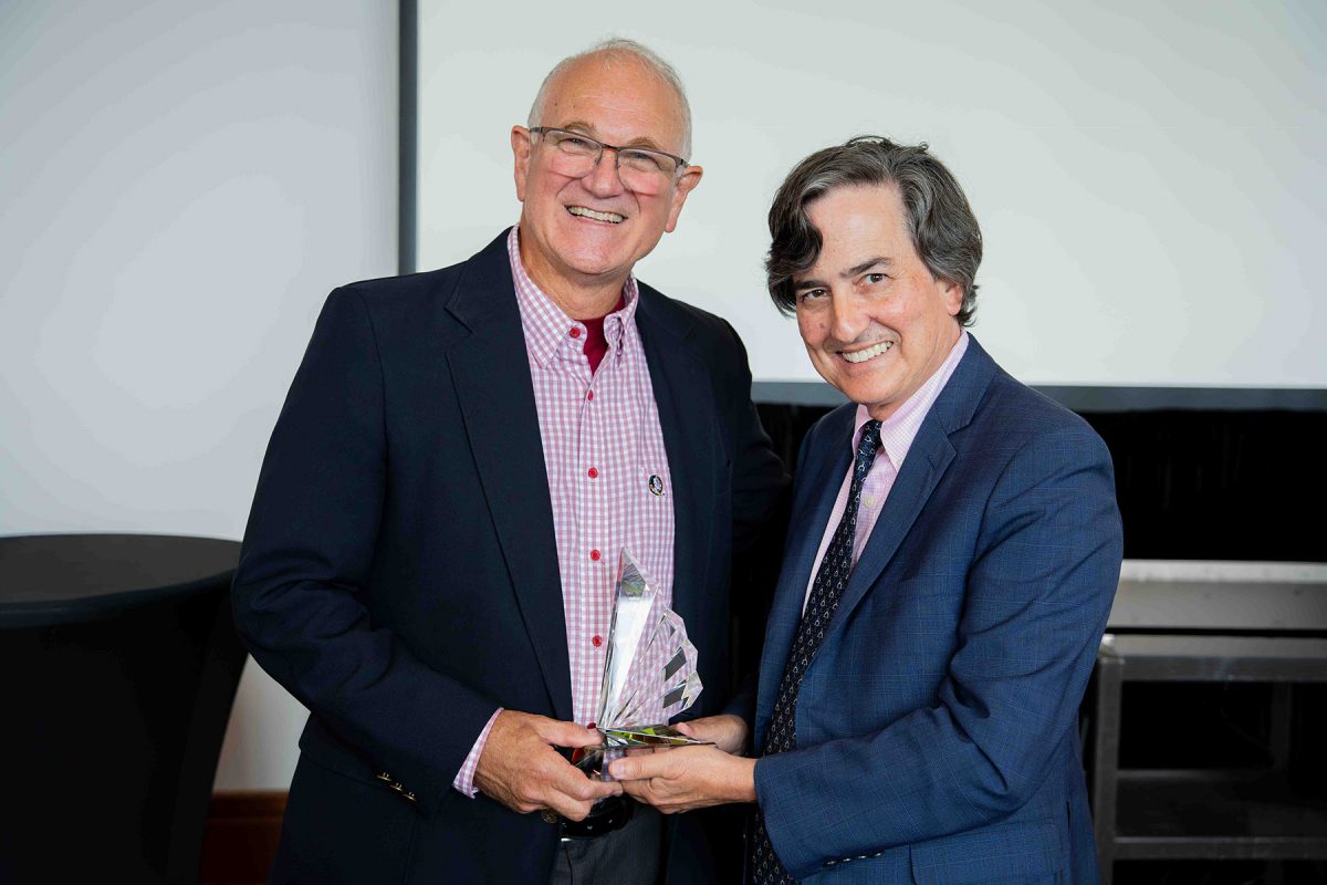 Provost Jim Clark and John Barnhill pose with an award.