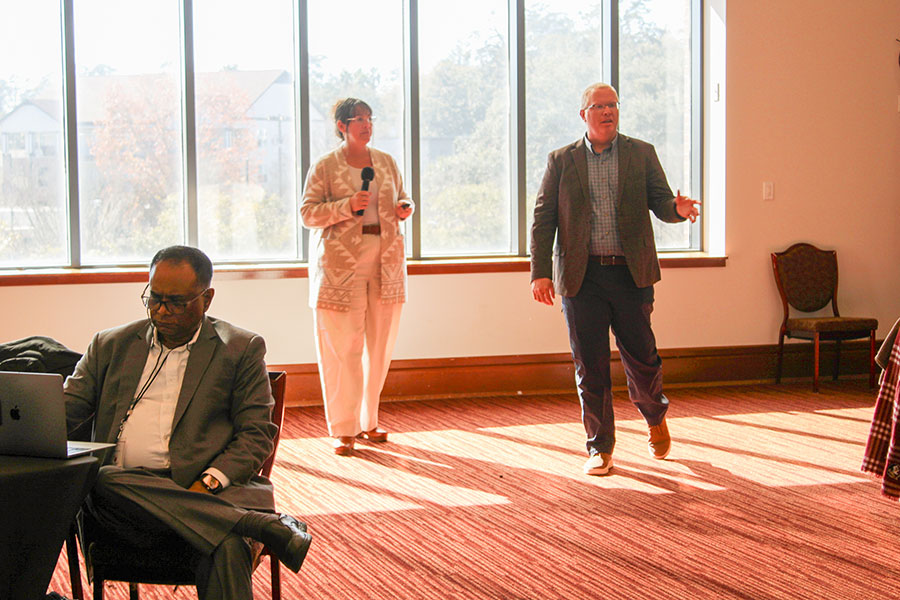 A woman and man speak to a crowd in Miller Hall on FSU's campus.