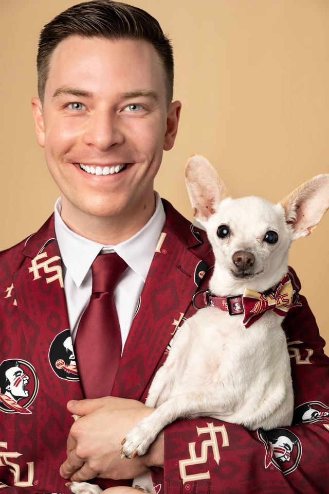 Professor Riley Krotz holds his dog, Grandpa, a dog he adopted and nursed for nine years until his pet’s passing early this year. (Photo from the Wertheim College of Business)
