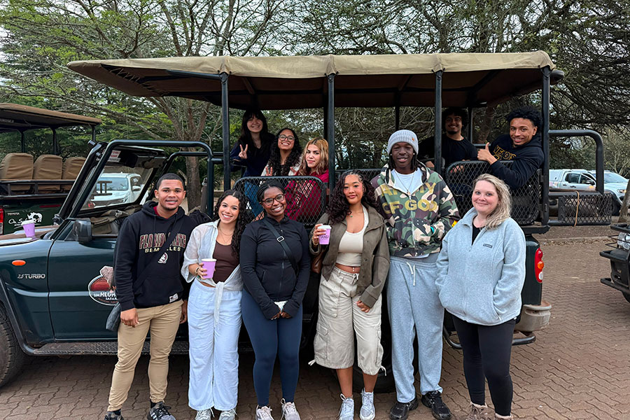 A group of students in front of a jeep before going on a game drive in South Africa.