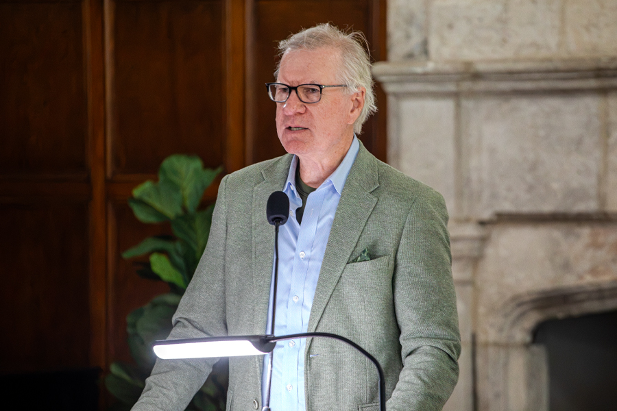 A person speaks behind a dais.
