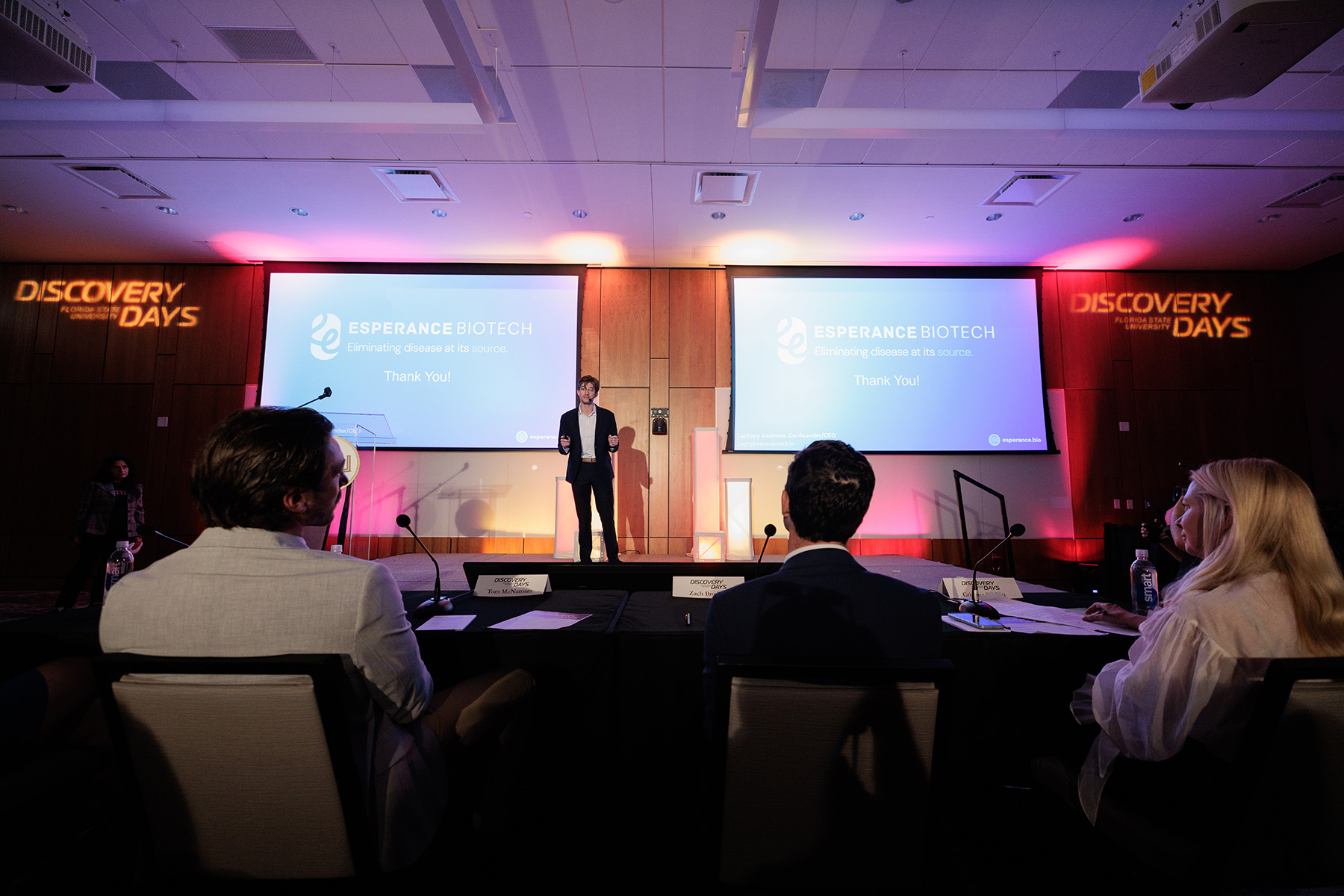 Zachary Asarnow presents on stage in front of judges.