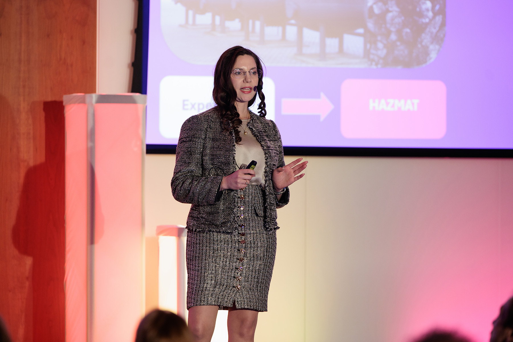 Kimberley Christopher speaks to an audience on stage.