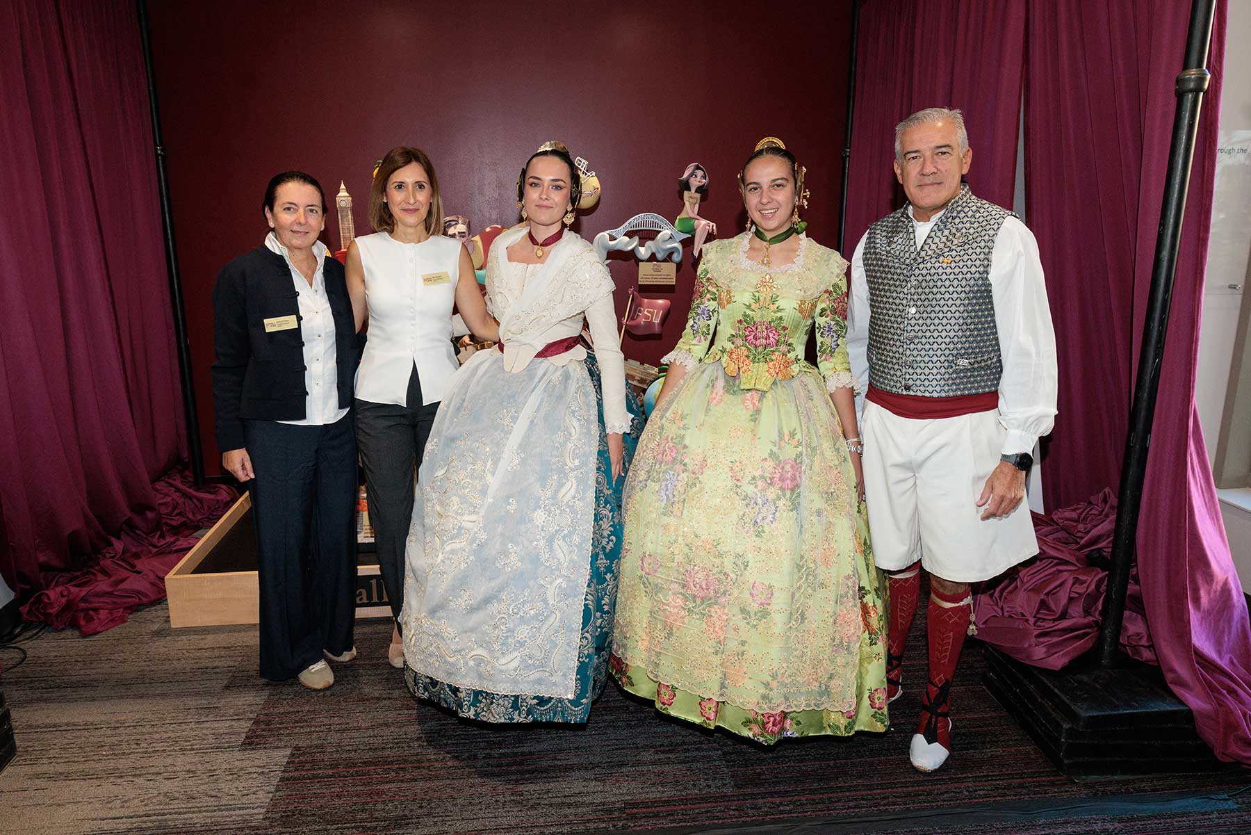 Five people stand in front of a fallas sculpture at FSU's Student Union.