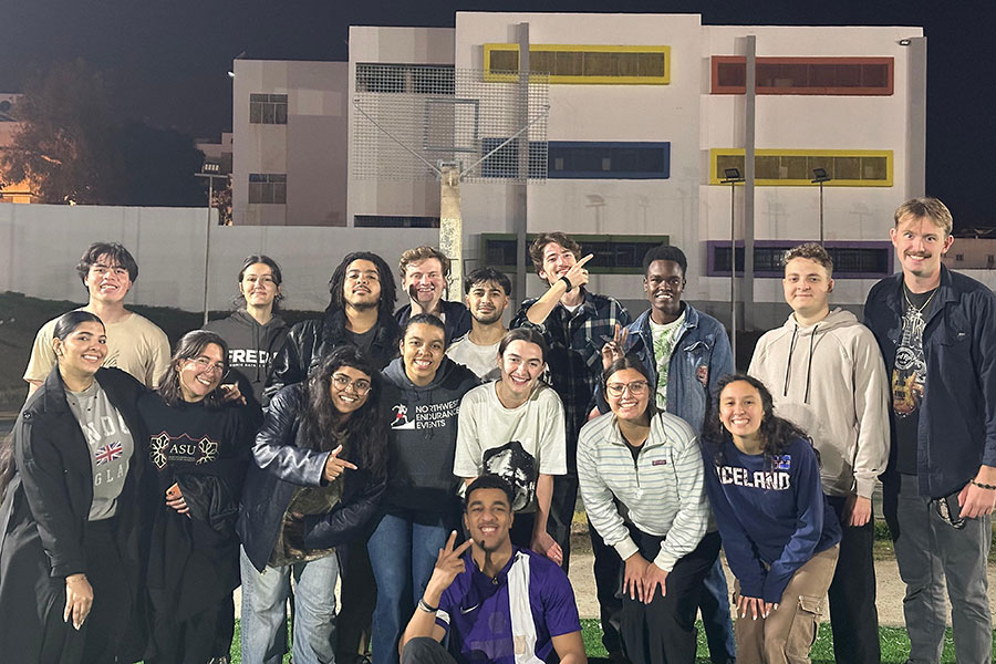Group photo of students outside at night.