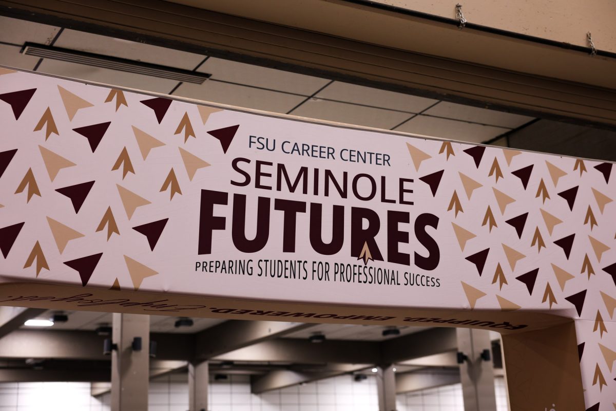 A sign overhead reads "FSU Career Center Seminole Futures: Preparing Students for Professional Success" patterned with garnet and gold spearheads.